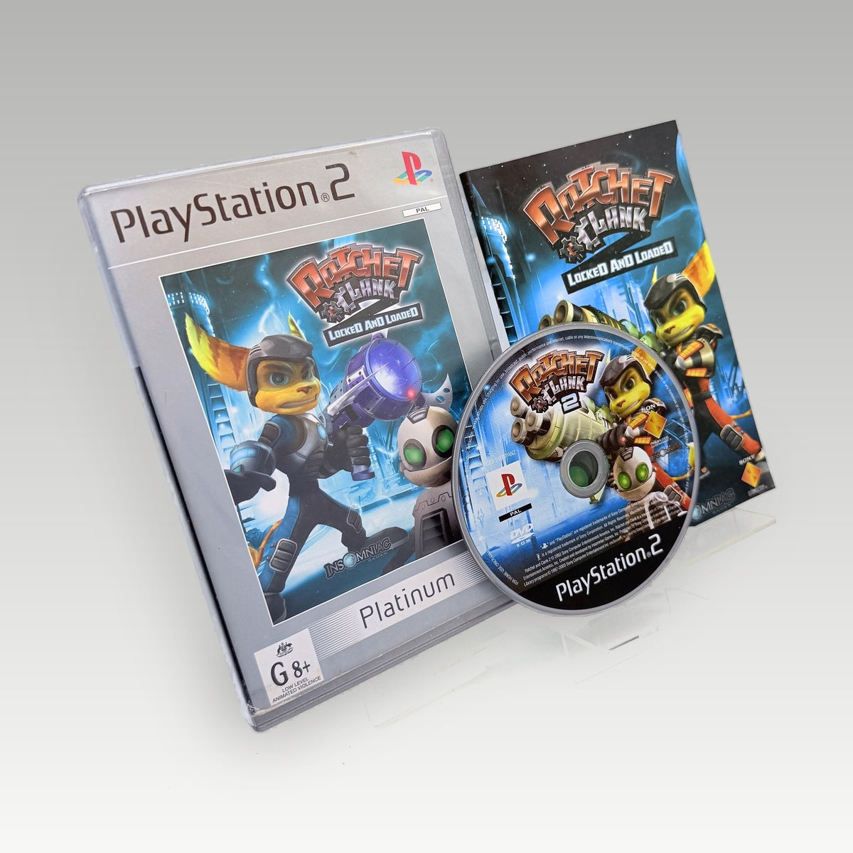 Ratchet & Clank 2: Locked & Loaded (Platinum) Original Disc • CIB (PAL, Original Disc) - Front Cover | Yappa NZ